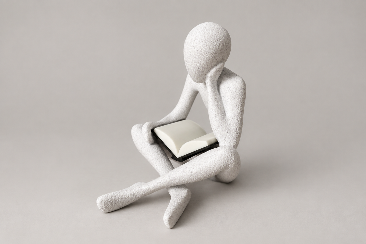 The Reader NObody sculpture in White Marble holding an open book, second front view.