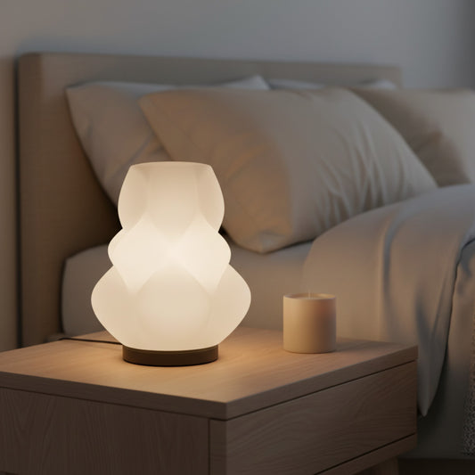 creative3dnovelties Lumen Bloom 3D printed jade white PLA lamp with organic petal design on a wooden bedside table