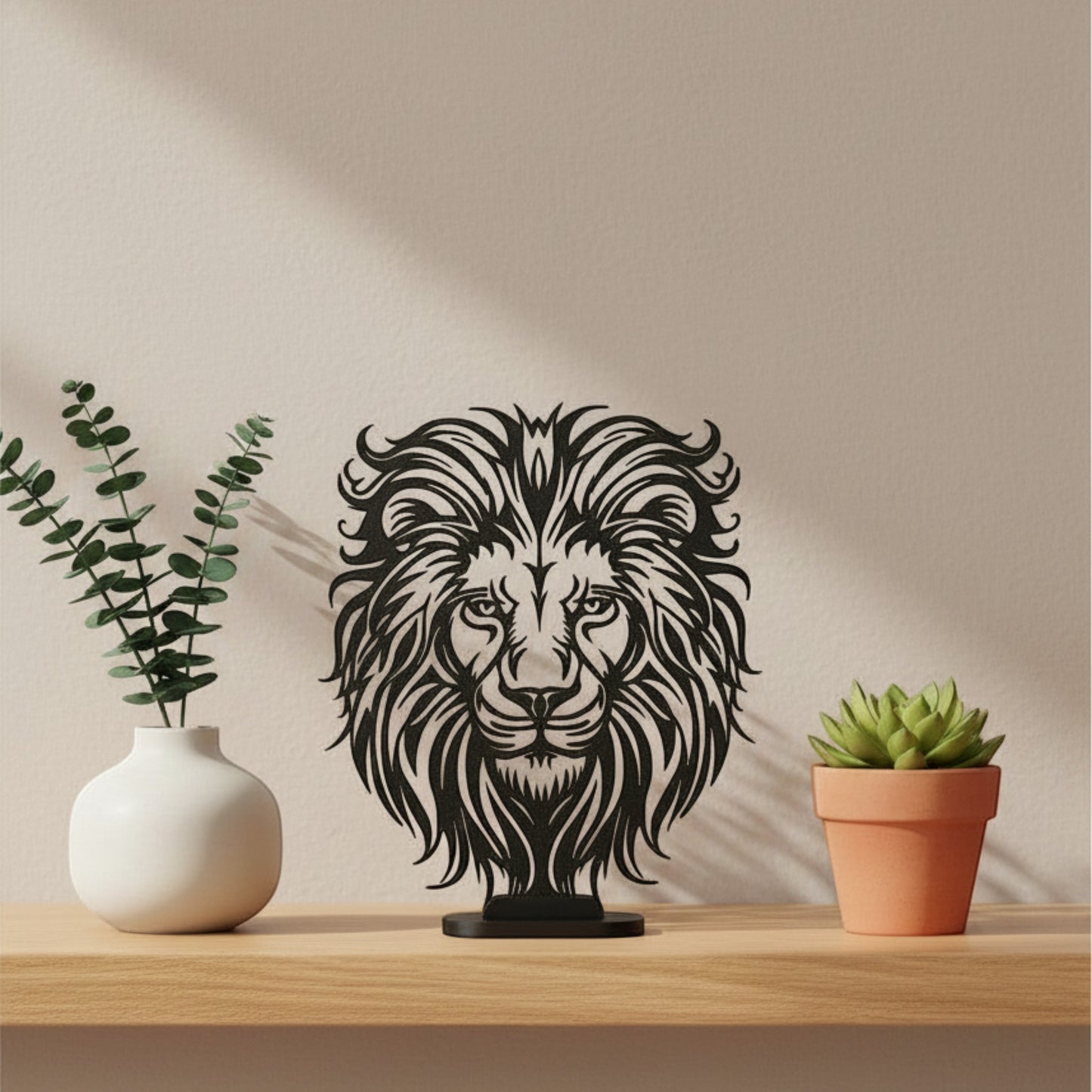 Matte charcoal flat display stand holding a black 3D printed lion head wall art piece on a wooden shelf, UK made