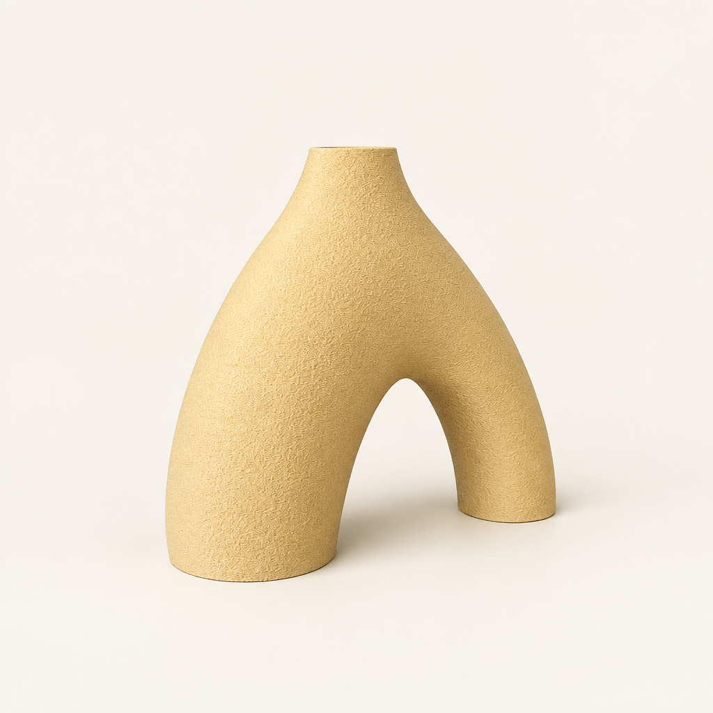 Bisect arch-shaped sculptural vase on a warm neutral studio background