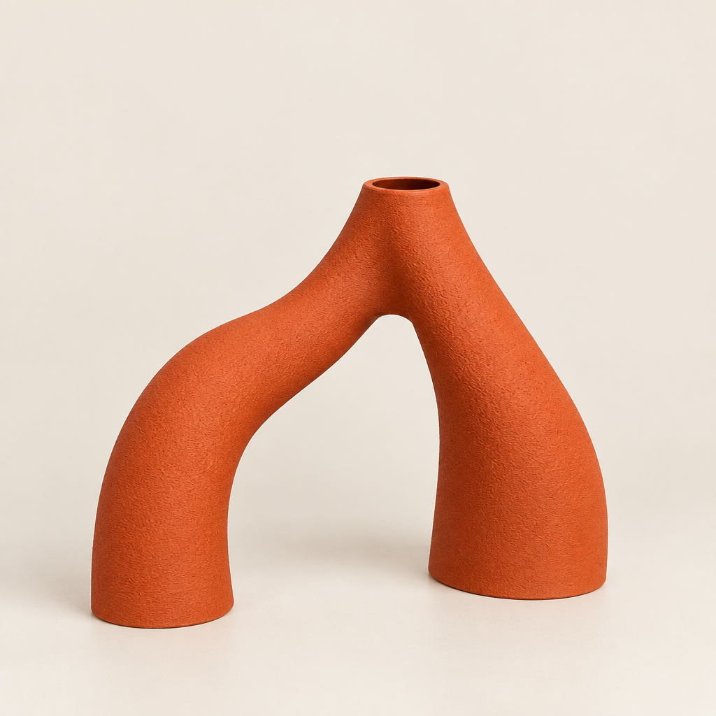 Individual Innesto vase in Matte Terracotta, showing its arched form and open top on a neutral background
