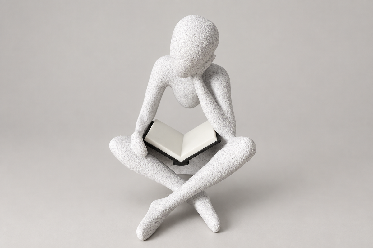 Side view of The Reader NObody sculpture in White Marble with the flat-page book.